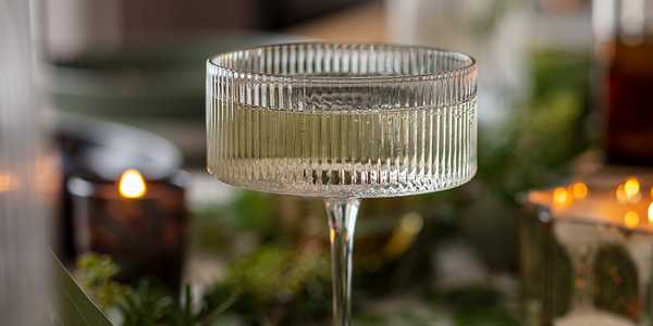 A ribbed champagne glass on a dining table. 
